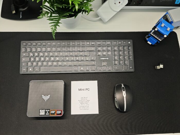 NiPoGi AM21 Mini PC auf dem Tisch vor Tastatur und Maus